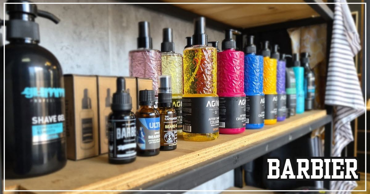 A row of brightly coloured grooming and shave bottles standing along a wooden shelf at Barbier, with the shop's wordmark in the corner.